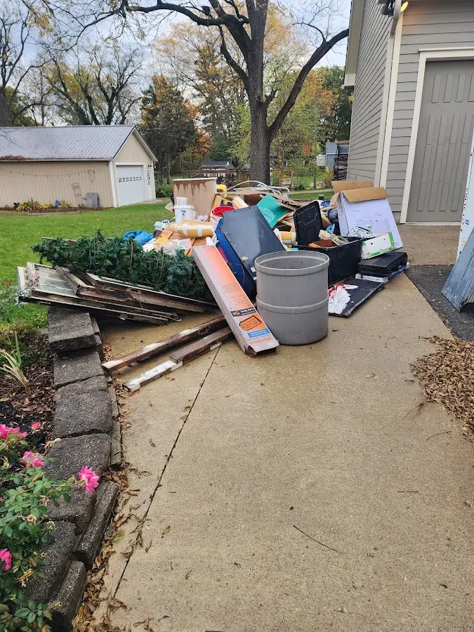 Dumpster being loaded with debris for Commercial Dumpster Rental in Olive Branch